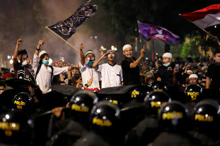 Protesters gesture during a protest across the Election Supervisory Agency (Bawaslu) headquarters following the announcement of the last month's presidential election results in Jakarta, Indonesia, May 22, 2019. REUTERS/Willy Kurniawan