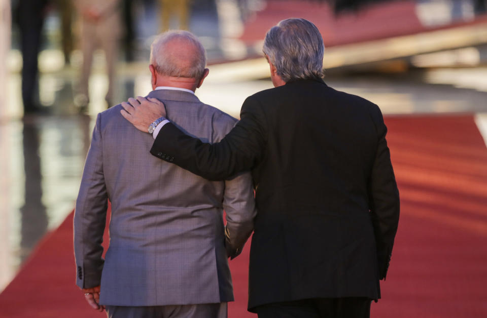 Brazilian President Luiz Inacio Lula da Silva, left, and Argentine President Alberto Fernandez walk into the Alvorada palace, after posing for photographers, in Brasilia, Brazil, Tuesday, May 2, 2023. (AP Photo/Gustavo Moreno)