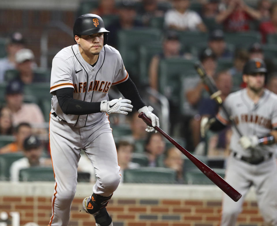 San Francisco Giants Wilmer Flores hits a 2-RBI single to take a 12-8 lead over the Atlanta Braves during the ninth inning of a baseball game on Tuesday, June 21, 2022, in Atlanta. (Curtis Compton Atlanta Journal-Constitution via AP)