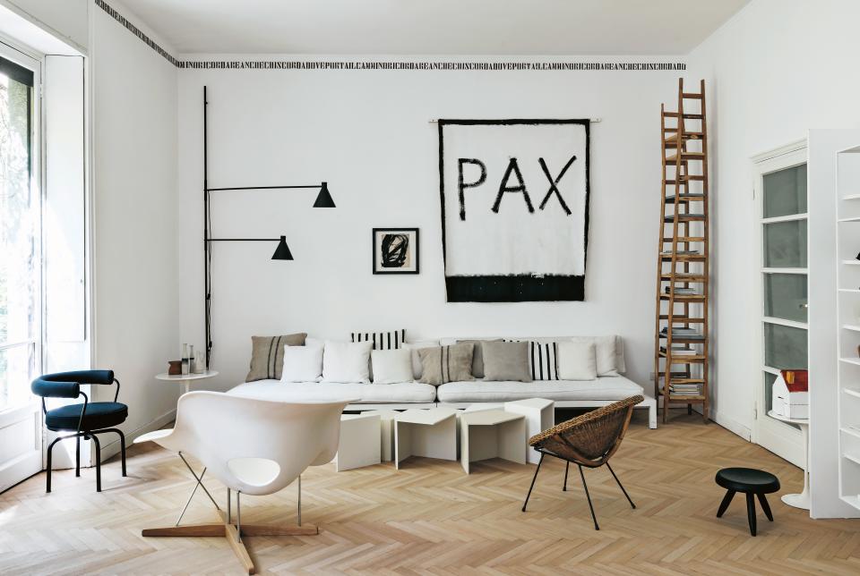 In her 1930s-era apartment in Milan, architect turned visual designer Elisa Ossino balances new designs with classic pieces, all united by a serene white-and-black palette. “I only want things that I like forever, pieces with history and objects where their story makes them something special,” she says. In the living room, an LC7 chair by Charlotte Perriand for Cassina and La Chaise by Eames for Vitra offset the rusticity of the wood accents and the laid-back lounge seating.