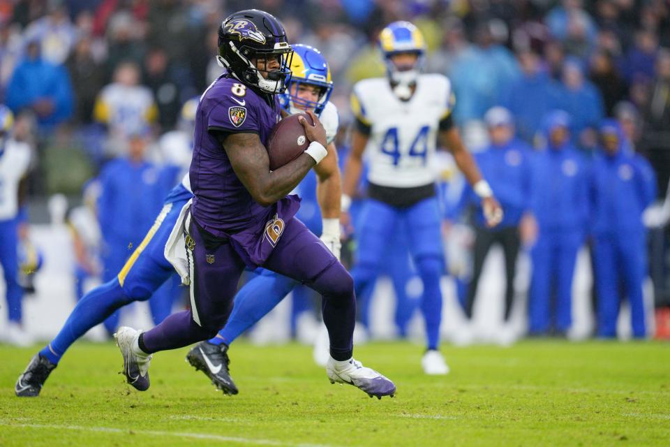 Baltimore, Maryland, USA; Baltimore Ravens quarterback Lamar Jackson (8) runs with the ball against the Los Angeles Rams during the second half at M&T Bank Stadium.