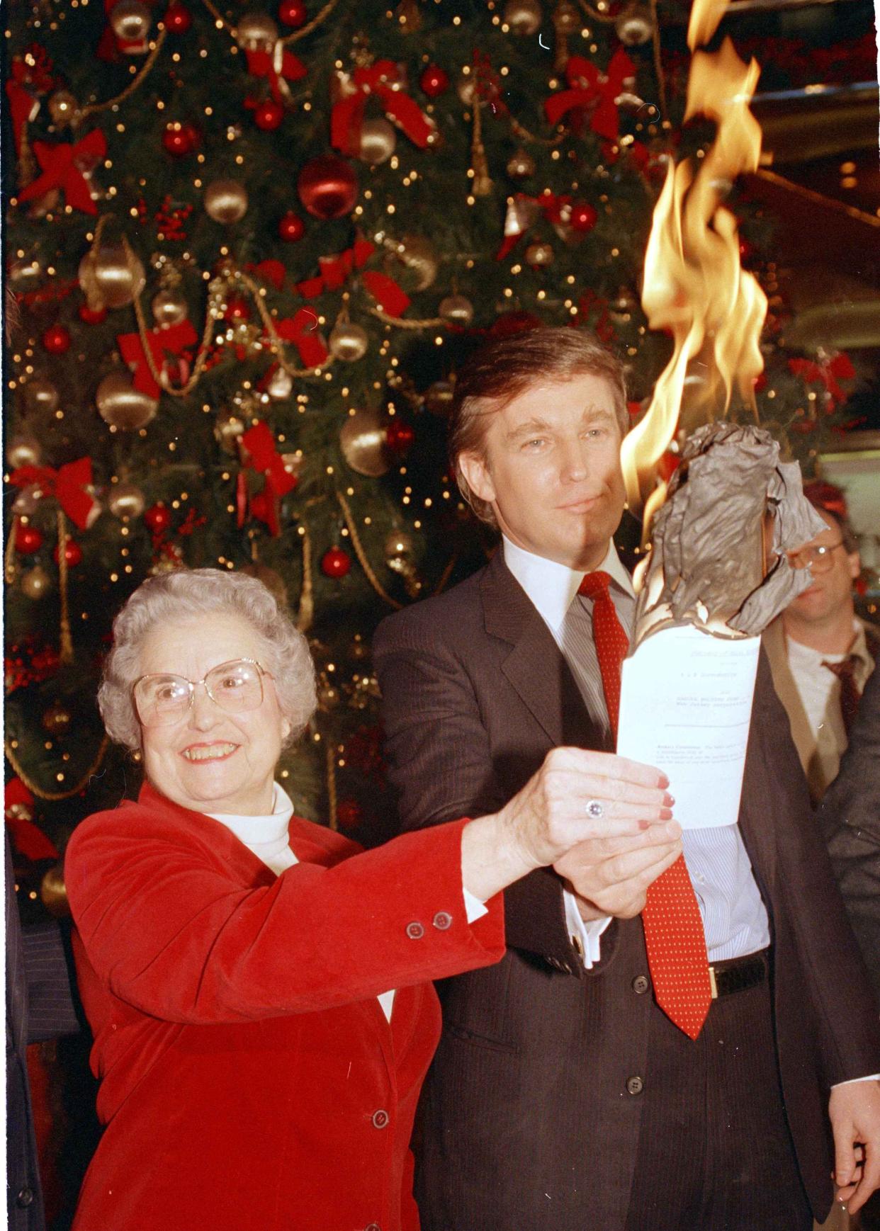 Annabel Hill of Waynesboro, Ga., burns the mortgage on her farm with the help of developer Donald Trump in New York, on Dec. 23, 1986. Mrs. Hill's husband Leonard, committed suicide early this year just minutes before their farm was to be auctioned for debts. Trump and a Dallas farmer heard about Mrs. Hill's troubles and together provided the last $73,000 to save the farm.