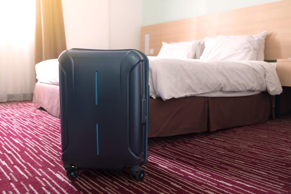 A suitcase in a hotel room.