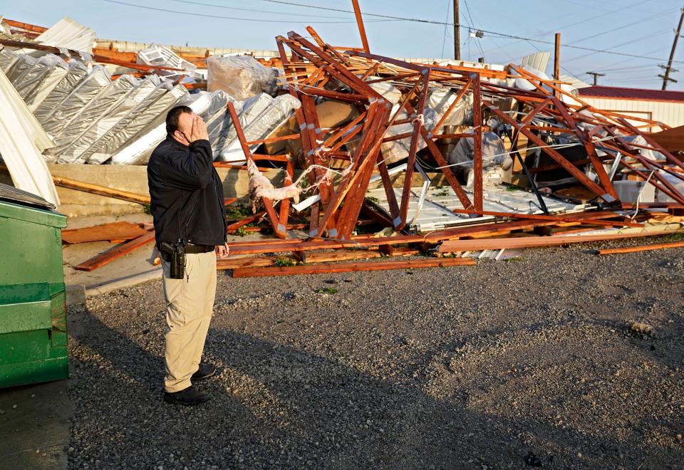 Justin Sloggett reacts while talking about his parents furniture store, The Saving Place Rustic Furniture and Mattress, after a suspected tornado destroyed their warehouse in Sapulpa, Okla., early Sunday, May 26, 2019.