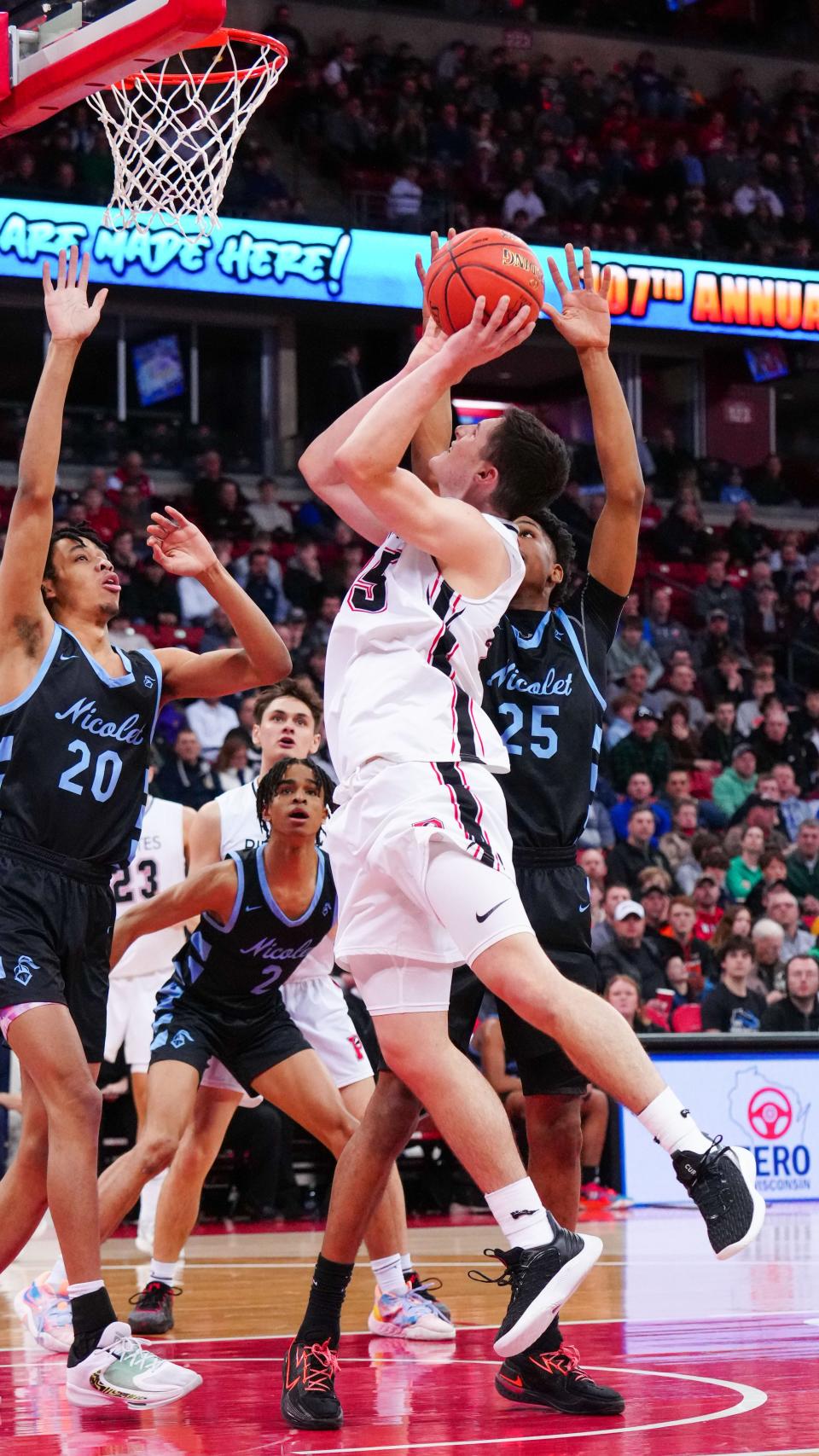 Pewaukee's Nick Janowski (25) elevates for two during the WIAA Division 2 state boys basketball semifinal against Nicolet at the Kohl Center in Madison on Friday, March 17, 2023.