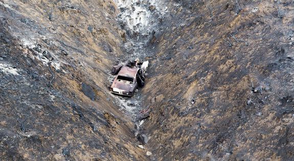 A scorched hillside and car is revealed after the La Tuna Fire moved through the Verdugo Mountains on Sunday, September 3, 2017.