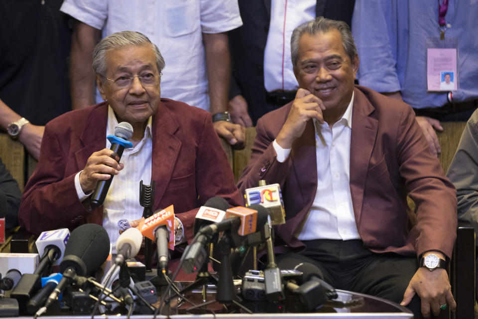 FILE - In this May 9, 2018, file photo, Mahathir Mohamad, left, speaks to the media at a hotel in Kuala Lumpur, Malaysia. Malaysia's king accepted Mahathir's shocking resignation Monday, Feb. 24, 2020, that came in tandem with plans by his supporters to team up with opposition parties to form a new government and foil the transition of power to his named successor, Anwar Ibrahim. (AP Photo/Vincent Thian, File)