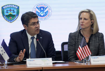 FILE PHOTO: Honduras' President Juan Orlando Hernandez speaks beside U.S. Secretary of Homeland Security Kirstjen Nielsen during a multilateral meeting at the Honduran Ministry of Security in Tegucigalpa, Honduras, March 27, 2019. REUTERS/Jorge Cabrera/File Photo