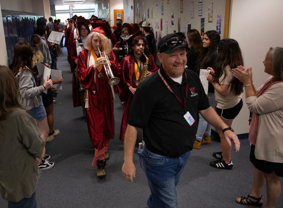 Willamette Principal Dan Hedberg leads Willamette and Kalapuya High School graduates as they parade through the halls of Prairie Mountain School on June 6.