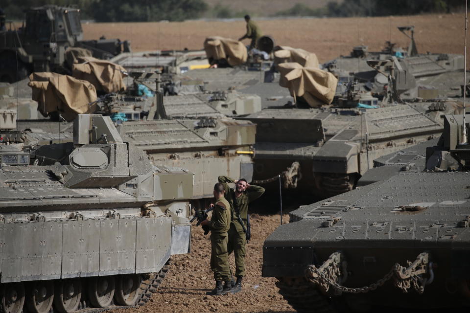 Israeli soldiers prepare their armored vehicles at a gathering point near the Israel--Gaza Border, Wednesday, Nov. 13, 2019. Israeli airstrikes killed more Islamic Jihad militants in Gaza on Wednesday as rocket fire toward Israel resumed after a brief overnight lull, raising the death toll in the strip to at least 18 Palestinians in the heaviest round of fighting in months. (AP Photo/Ariel Schalit)