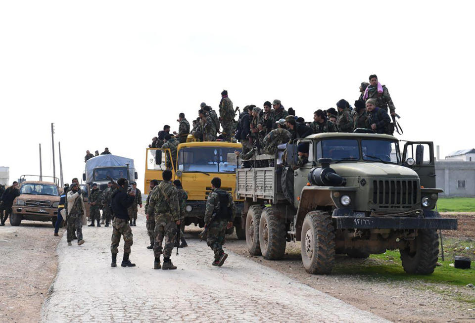 In this photo released Wednesday Feb. 5, 2020 by the Syrian official news agency SANA, shows Syrian government forces entering the village of Tel-Sultan, in Idlib province, northwest Syria. On Thursday, State media and opposition activists said Turkey has sent more reinforcements into northwestern Syria, setting up new positions in an attempt to stop a government offensive on the last rebel stronghold in the war-torn country. (SANA via AP)