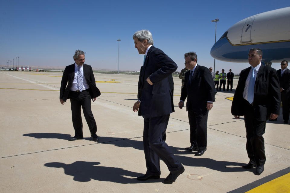 U.S. Secretary of State John Kerry, center, arrives in Amman, Jordan on Wednesday, March 26, 2014. Kerry arrived in Jordan in hopes of jump-starting foundering Mideast peace talks just as Arab leaders released a communique saying they will never recognize Israel as a Jewish state. (AP Photo/Jacquelyn Martin, Pool)