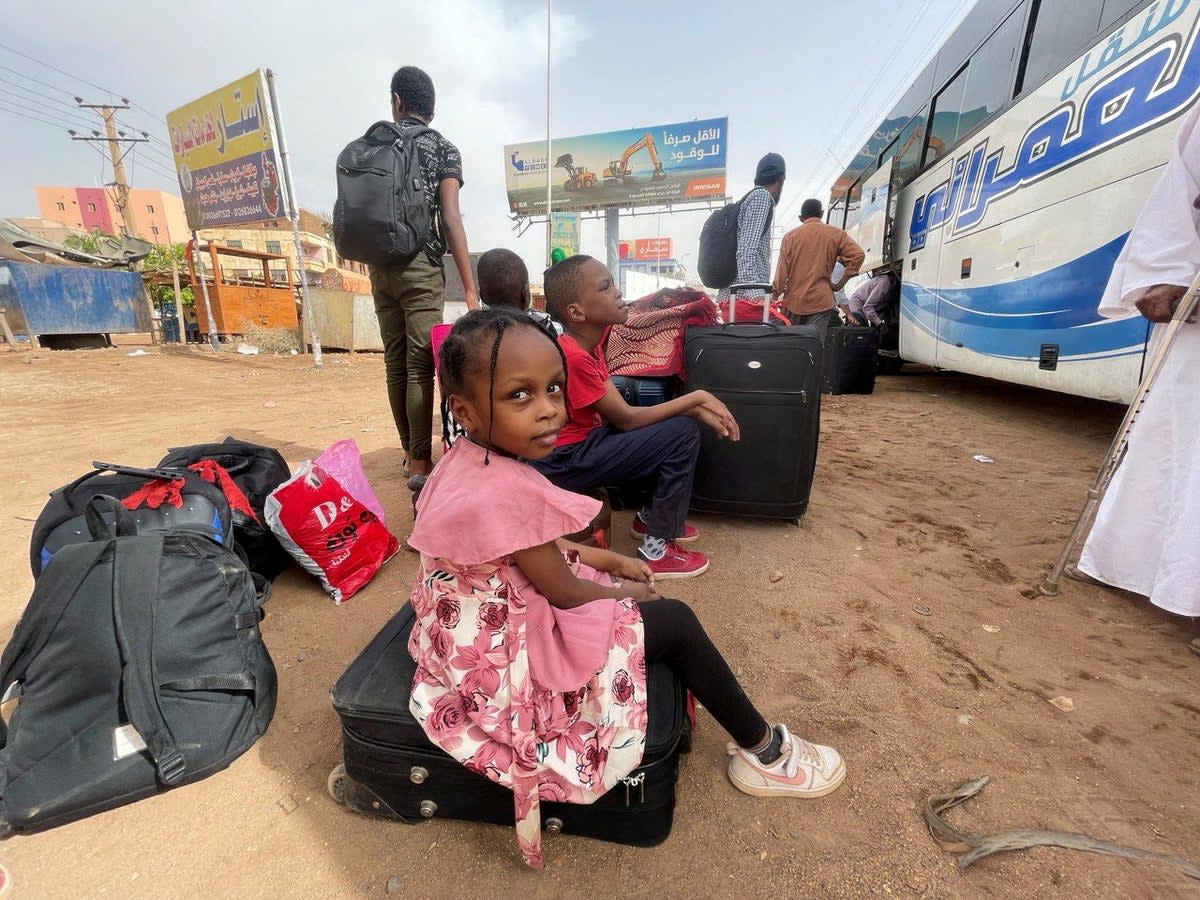 People in Khartoum flee clashes between the paramilitary RSF and the army (Reuters)