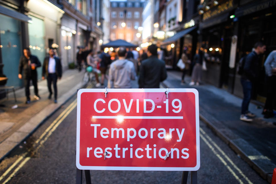 People eat and drink oudoors in Soho, London, as coronavirus lockdown restrictions are eased across England. Many streets in Soho were pedestrianised for the night, and bars and restaurants added extra outdoor seating. Picture date: Sunday July 5, 2020. Photo credit should read: Matt Crossick/Empics