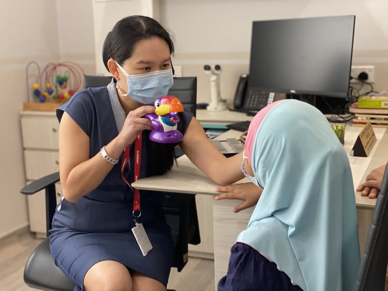 Sunway Medical Centre Velocity's (SMCV) Dr Fiona Chew performing the orthoptics assessment to check the squint angle on Mia Syuhada Sabdani. — Photo by Jasmin Zainal