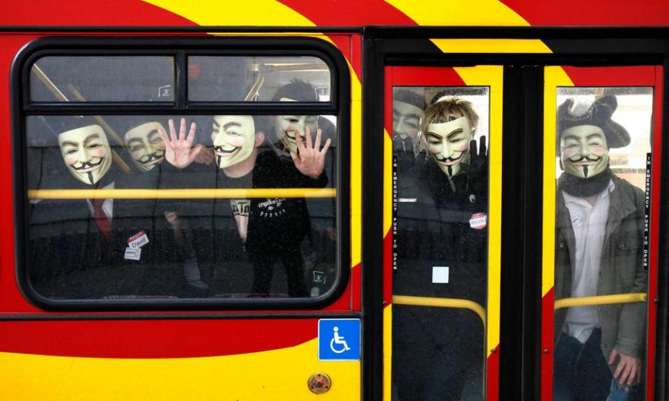 Protesters wearing masks on a bus.
