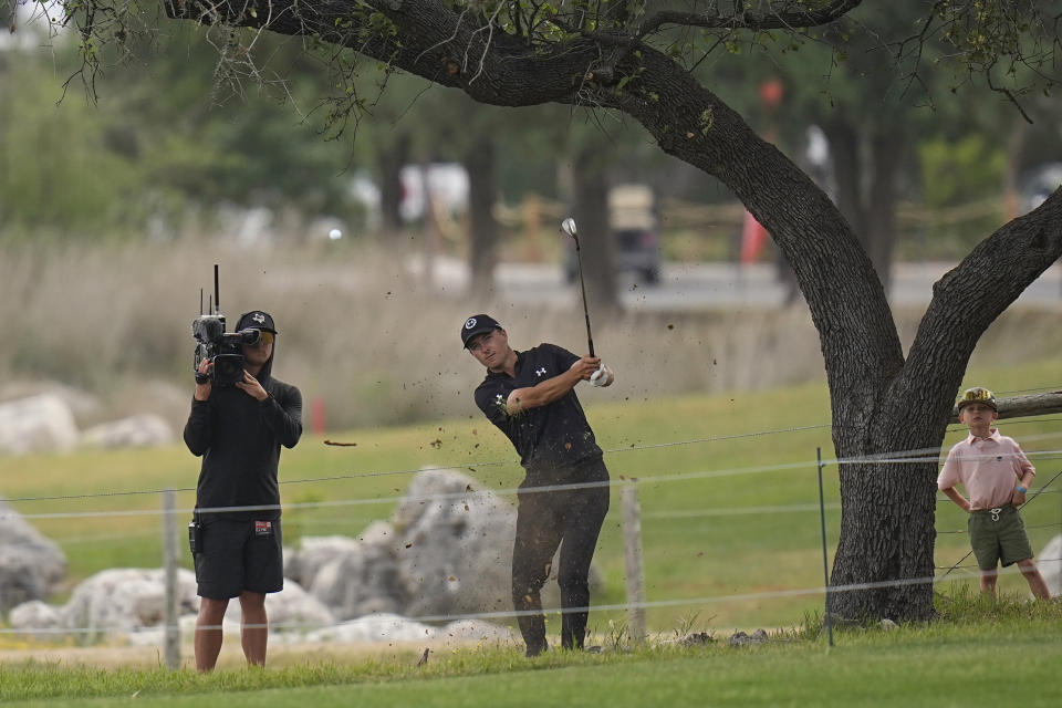 Jordan Spieth hits from the rough on the 18th hole during the third round of the Texas Open golf tournament, Saturday, April 6, 2024, in San Antonio. (AP Photo/Eric Gay)