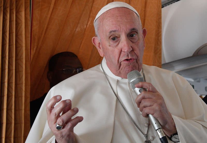 Pope Francis speaks to the media on board an Alitalia aircraft