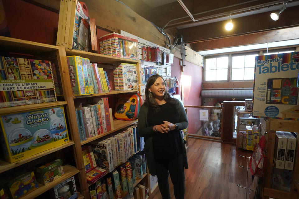 Stephanie Sala, owner of Five Little Monkeys, smiles while interviewed at her store in Berkeley, Calif., Monday, Dec. 12, 2022. Small retailers say this year looks much different than the last "normal" pre-pandemic holiday shopping season of 2019. They're facing decades-high inflation forcing them to raise prices and making shoppers rein in the freewheeling spending seen in 2021 when they were flush with pandemic aid and eager to spend. (AP Photo/Jeff Chiu)