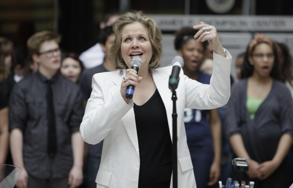 Famed soprano Renee Fleming performs with world-famous cellist Yo-Yo Ma and a choir of dozens of high school students in the rotunda of the State of Illinois building, the James R. Thompson Center, Monday, March 19, 2012, in Chicago. The Monday afternoon performance was to promote the Chicago Symphony Orchestra's Citizen Musician initiative. The Lyric Opera of Chicago also sponsored the event and Illinois Gov. Pat Quinn attended. (AP Photo/Kiichiro Sato)