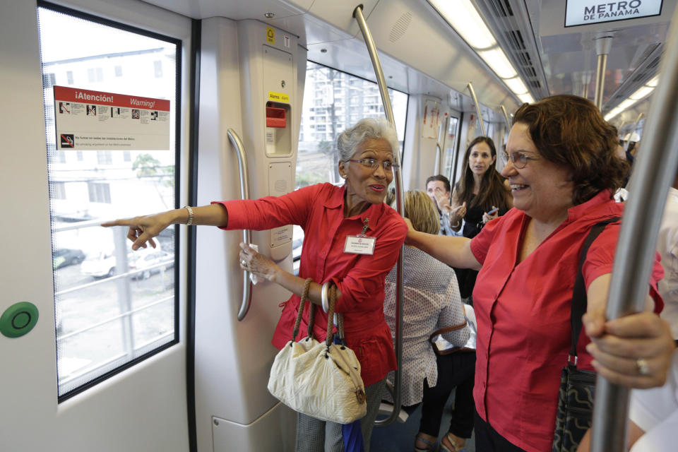 In this Wednesday, April 2, 2014 photo, government employees and their guests ride on a subway while participating in an invitation to test the wagons of the new Panama Metro in Panama City. Central America’s first underground metro will surely alleviate the booming capital’s dreadful traffic. But critics say the $2 billion spent on the 14-kilometer rail project, which was marred by cost overruns, would’ve been better used building a higher-capacity, surface transport network. They also are blasting the timing of the over-the-top inauguration set for Saturday, April 5, which they say is a political stunt by President Ricardo Martinelli to drum up support for his preferred successor. (AP Photo/Arnulfo Franco)