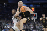 Charleston guard Dalton Bolon (3) is fouled by San Diego State guard Lamont Butler (5) while going up for a shot during the first half of a first-round college basketball game in the NCAA Tournament, Thursday, March 16, 2023, in Orlando, Fla. (AP Photo/Phelan M. Ebenhack)