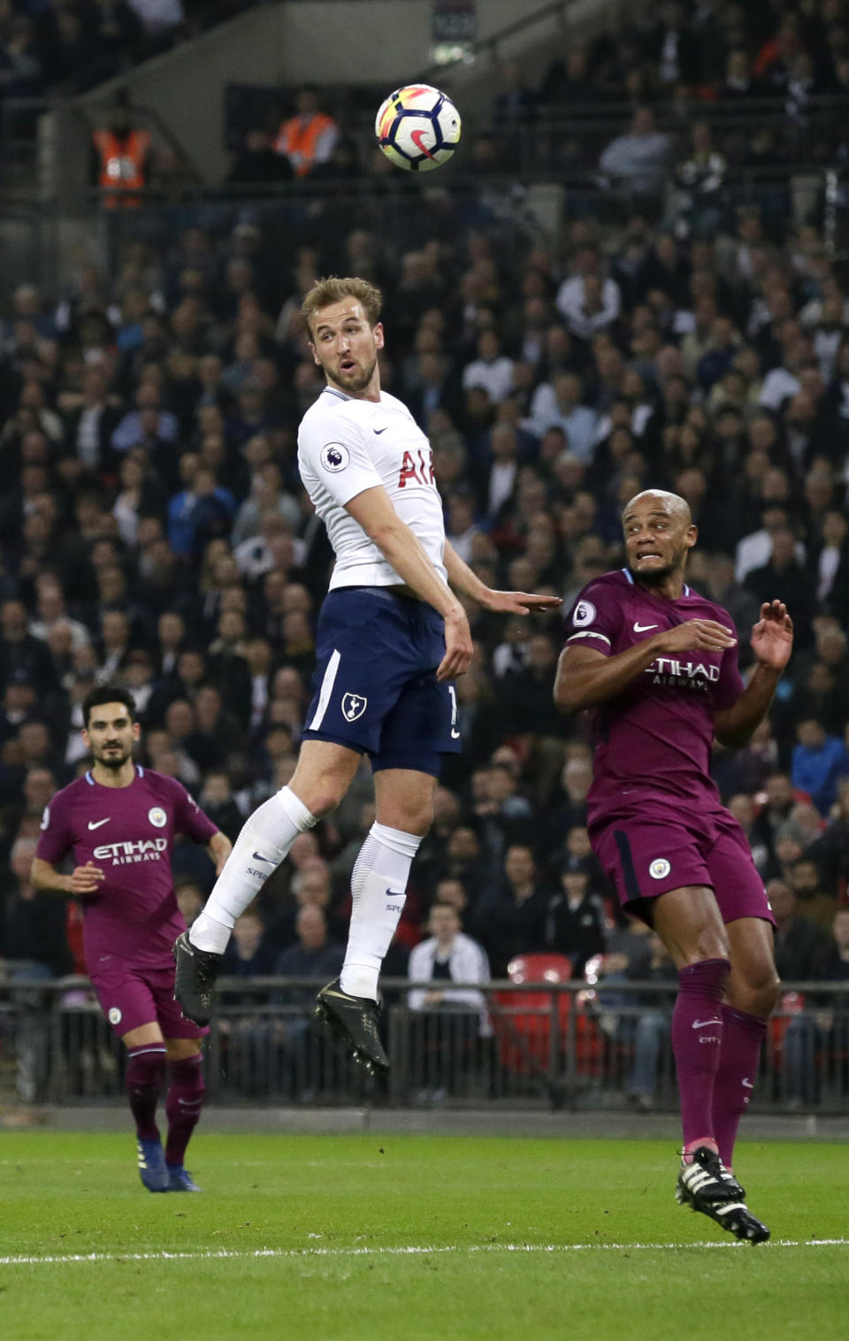 <p>Tottenham’s Harry Kane jumps for the ball with Manchester City’s Vincent Kompany </p>