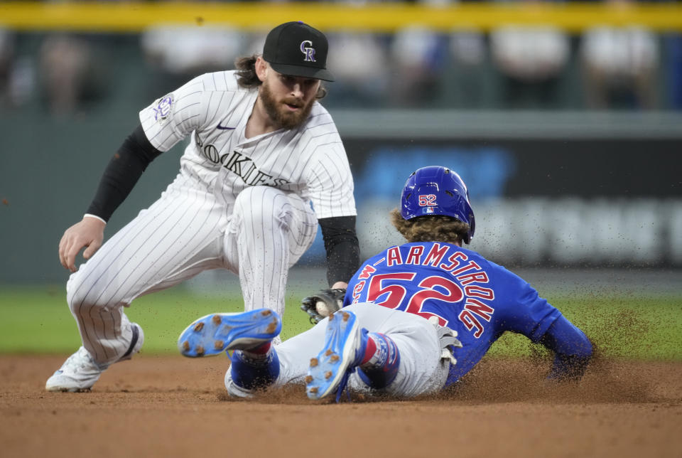 Colorado Rockies second baseman Brendan Rodgers, left, tags out Chicago Cubs' Pete Crow-Armstrong on an attempted steal during the second inning of a baseball game Tuesday, Sept. 12, 2023, in Denver. (AP Photo/David Zalubowski)