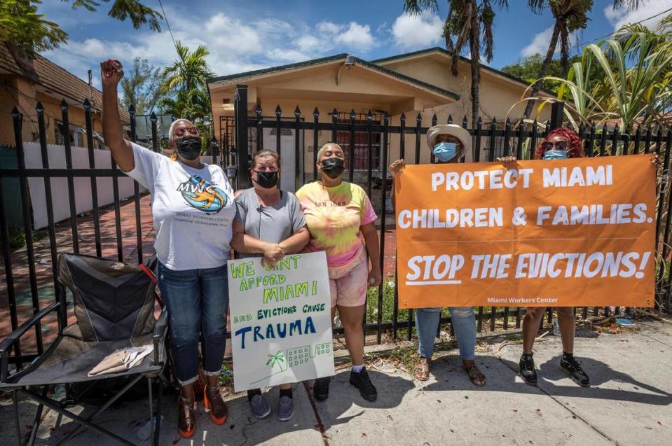 Elena Riech, second from left, holds a sign in protest of her eviction in front of the house she rents in Allapatah along with folks from the Miami Workers Center who came out to support her on Tuesday, June 8.