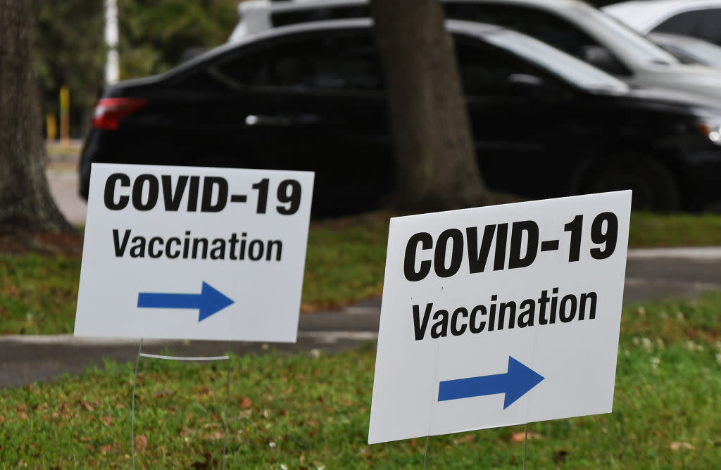 Signs posted at a FEMA COVID-19 vaccination site at the