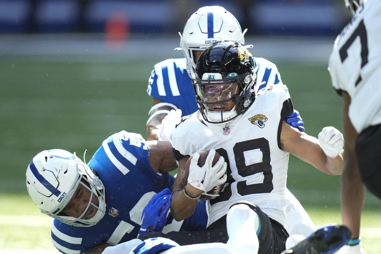 Jacksonville Jaguars' Luke Farrell (89) is tackled by Indianapolis Colts' Bobby Okereke (58) during the first half of an NFL football game, Sunday, Oct. 16, 2022, in Indianapolis.(AP Photo/AJ Mast)