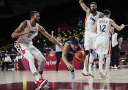 United States' guard Devin Booker, center, falls as he is fouled by France's Rudy Gobert (27) during a men's basketball preliminary round game at the 2020 Summer Olympics, Sunday, July 25, 2021, in Saitama, Japan. (AP Photo/Eric Gay)