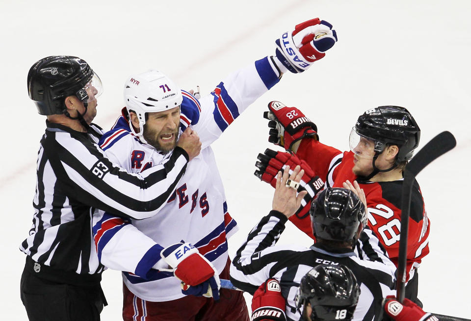 NEWARK, NJ - MAY 21: Linesman Brian Murphy #93 separates Mike Rupp #71 of the New York Rangers and Anton Volchenkov #28 of the New Jersey Devils in Game Four of the Eastern Conference Final during the 2012 NHL Stanley Cup Playoffs at the Prudential Center on May 21, 2012 in Newark, New Jersey. (Photo by Jim McIsaac/Getty Images)