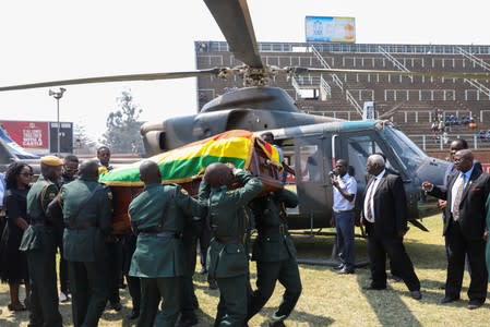 A casket carrying the remains of Robert Mugabe is brought to lie in state at the at Rufaro stadium