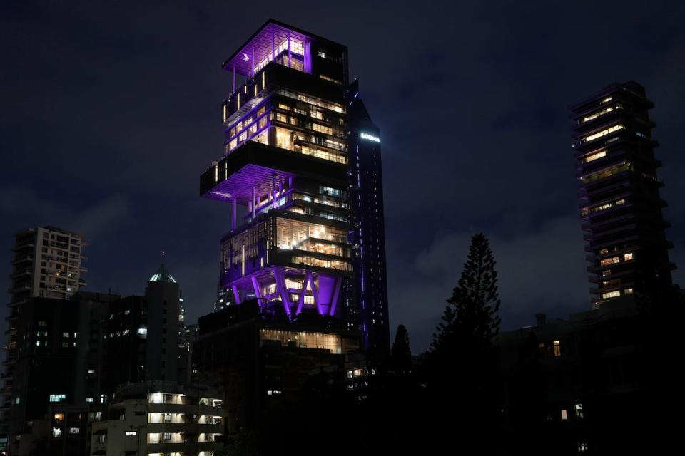 The Antilia mansion, house of billionaire Mukesh Ambani, is lit up ahead of his son Anant Ambani and Radhika Merchant's wedding in Mumbai Wednesday. 