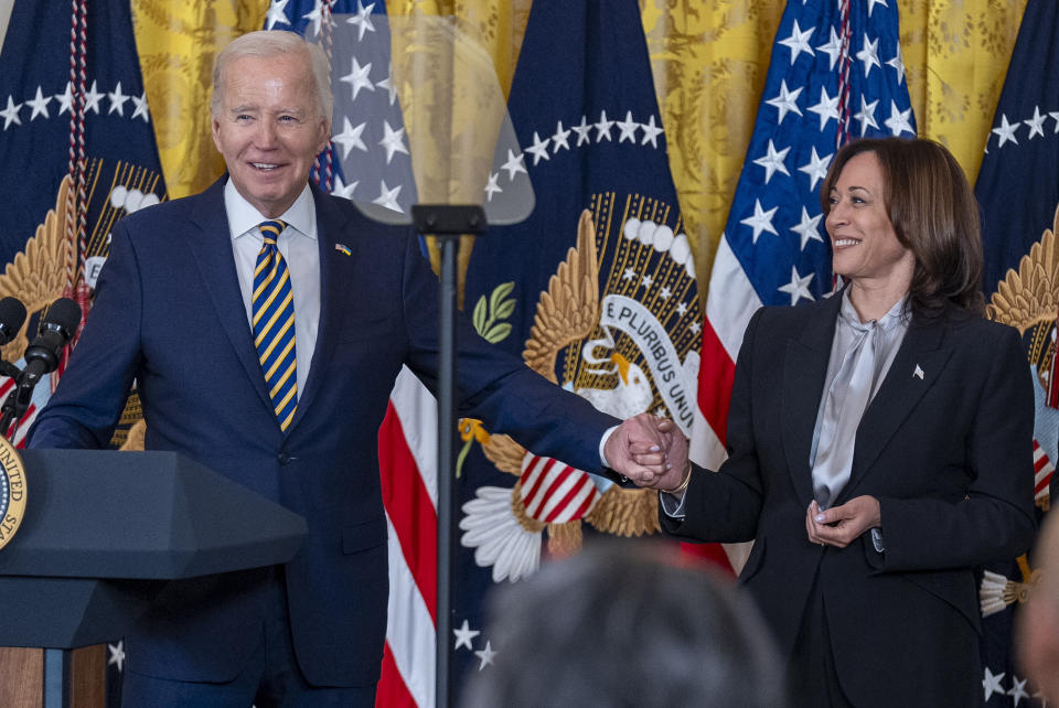President Joe Biden, holds hands with Vice President Kamala Harris as he speaks at a reception in recognition of Black History Month in the East Room of the White House in Washington, Tuesday, Feb. 6, 2024. (AP Photo/Andrew Harnik)