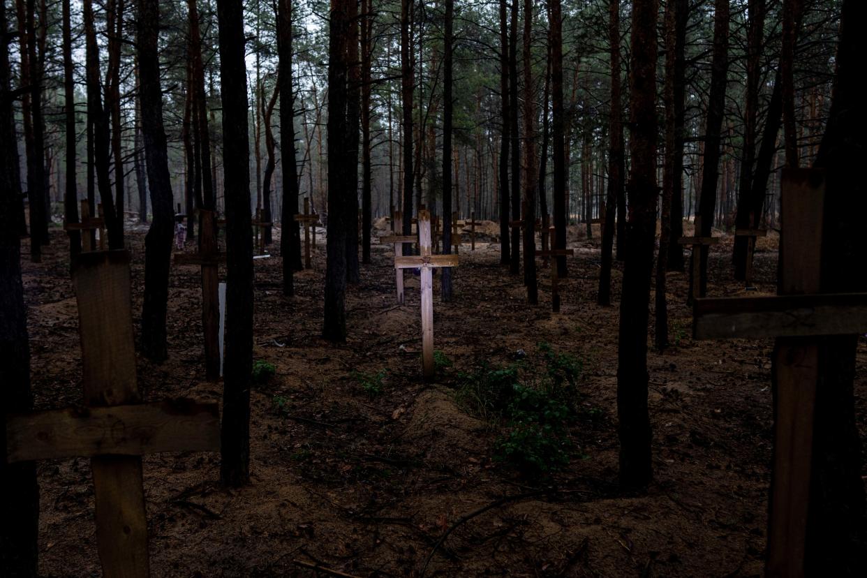 Unidentified graves of civilians and Ukrainian soldiers are marked with a cross in a cemetery in the recently liberated town of Izium, Ukraine, Thursday, Sept. 15, 2022. At the mass grave site created by the Russians and discovered in the woods of Izium, at least 30 of the 447 bodies recently excavated bore visible marks of torture – bound hands, close gunshot wounds, knife wounds and broken limbs, according to the Kharkiv regional prosecutor's office.