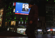 A photo of late Chinese President Jiang Zemin is seen on a big screen during the evening news broadcast of his death at a mall in Beijing, Wednesday, Nov. 30, 2022. Jiang Zemin, who led China out of isolation after the army crushed the Tiananmen Square pro-democracy protests in 1989 and supported economic reforms that led to a decade of explosive growth, died Wednesday. He was 96. (AP Photo/Ng Han Guan)