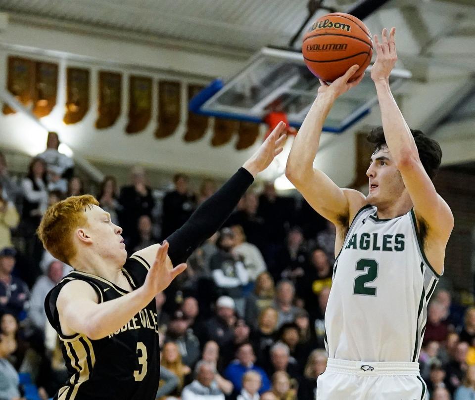 Zionsville Eagles guard Logan Imes (2) shoots the ball against Noblesville Millers guard Aaron Fine (3) during the IHSAA Class 4A sectional final on Saturday, March 4, 2023 at Carmel High School in Carmel. The Noblesville Millers defeated the Zionsville Eagles, 58-50. 