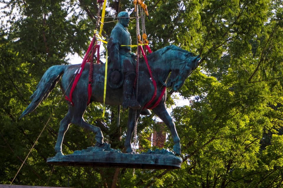 Workers remove the monument of Confederate General Robert E. Lee on Saturday, July 10, 2021 in Charlottesville, Va.   The removal of the Lee statue follows years of contention, community anguish and legal fights.