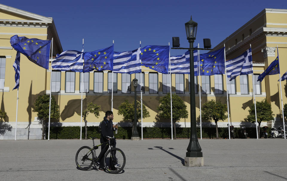 Greek and European Union's flags wave outside Zappeio Hall in Athens, on Friday, Jan. 23, 2015. (AP Photo/Thanassis Stavrakis)