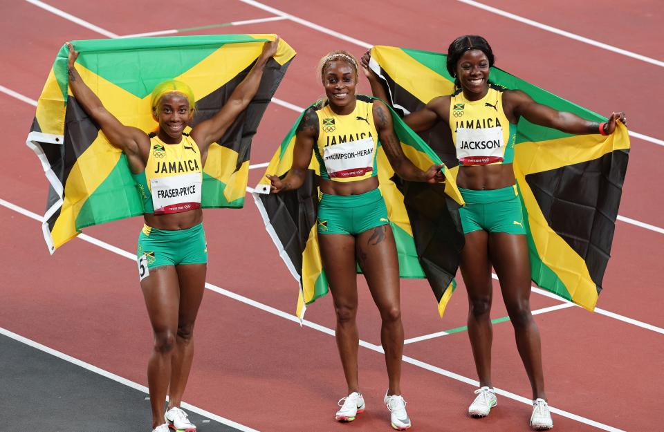 Jamaica's Shelly-Ann Fraser-Pryce, Jamaica's Elaine Thompson-Herah and Jamaica's Shericka Jackson pose for a group picture after the women's 100m final at the Tokyo 2020 Olympic Games.(Photo by GIUSEPPE CACACE/AFP via Getty Images)