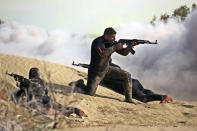 In this photo released Tuesday, Jan. 19, 2021, by the Iranian Army, troops participate in a military drill. Iran's military kicked off a ground forces drill on Tuesday along the coast of the Gulf of Oman, state TV reported, the latest in a series of snap exercises that the country is holding amid escalating tensions over its nuclear program and Washington's pressure campaign against Tehran. (Iranian Army via AP)