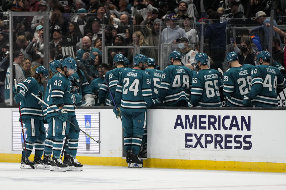 San Jose Sharks players leave the ice after the team's 3-2 shootout loss to the Los Angeles Kings in an NHL hockey game Saturday, Dec. 17, 2022, in Los Angeles. (AP Photo/Jae C. Hong)