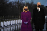 President-elect Joe Biden and Jill listen during a COVID-19 memorial, with lights placed around the Lincoln Memorial Reflecting Pool, Tuesday, Jan. 19, 2021, in Washington. (AP Photo/Alex Brandon)