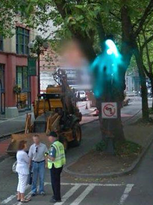 The blue apparition appears to hover above people on the street. Photo: Google