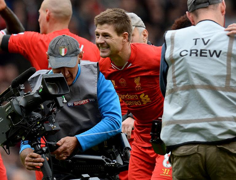 Liverpool's Steven Gerrard (C) celebrates at the final whistle during their English Premier League match against Manchester City, at Anfield in Liverpool, on April 13, 2014