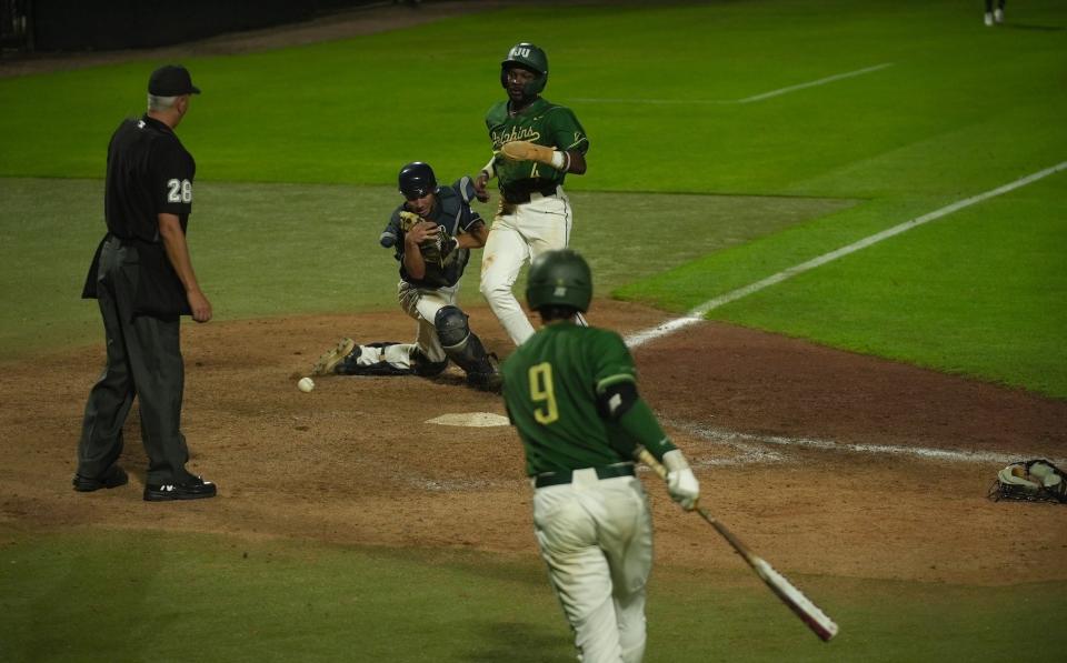 Jacksonville University runner Tyrell Brewer is called out at the plate in the eighth inning after being tagged by University of North Florida catcher Jabin Bates. The umpire ruled Bates held onto the ball long enough to tag Brewer.