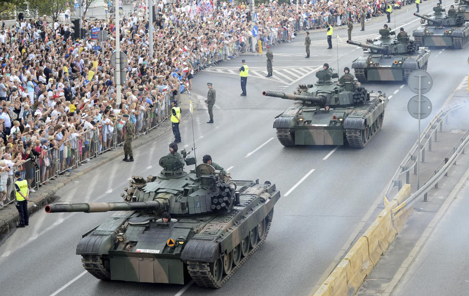 Tanks roll on one of the city's main streets during a yearly military parade celebrating the Polish Army Day in Warsaw, Poland, Wednesday, Aug. 15, 2018. Poland marks Army Day with a parade and a call for US permanent military base in Poland. (AP Photo/Alik Keplicz)