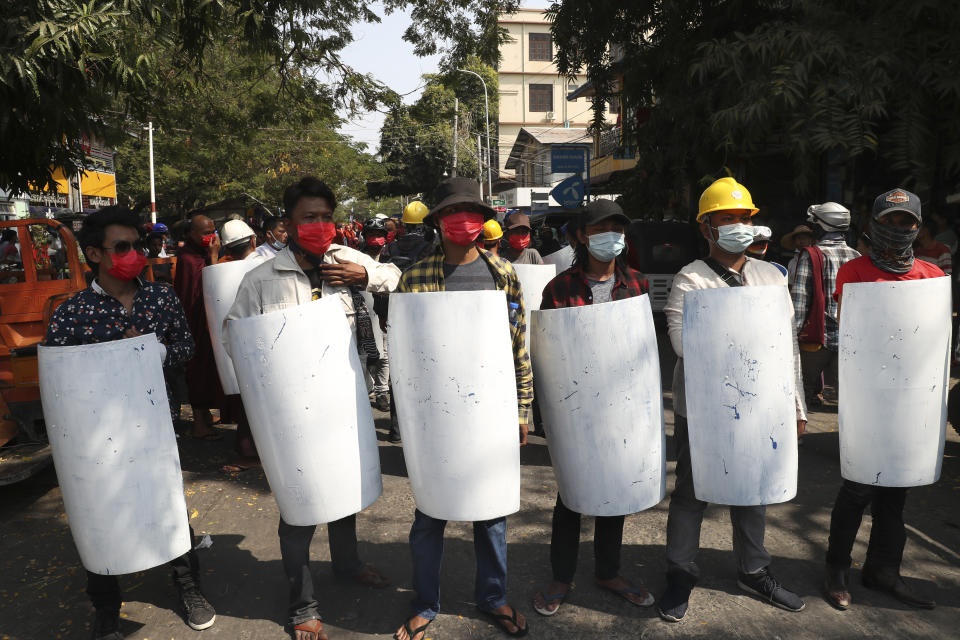 Protesters hold homemade shield during an anti-coup protest march in Mandalay, Myanmar, Monday, March 1, 2021. Police in Myanmar’s biggest city of Yangon on Monday fired tear gas at defiant crowds who returned to the streets to protest the military’s seizure of power a month ago, despite reports that security forces had killed at least 18 people around the country a day earlier.(AP Photo)